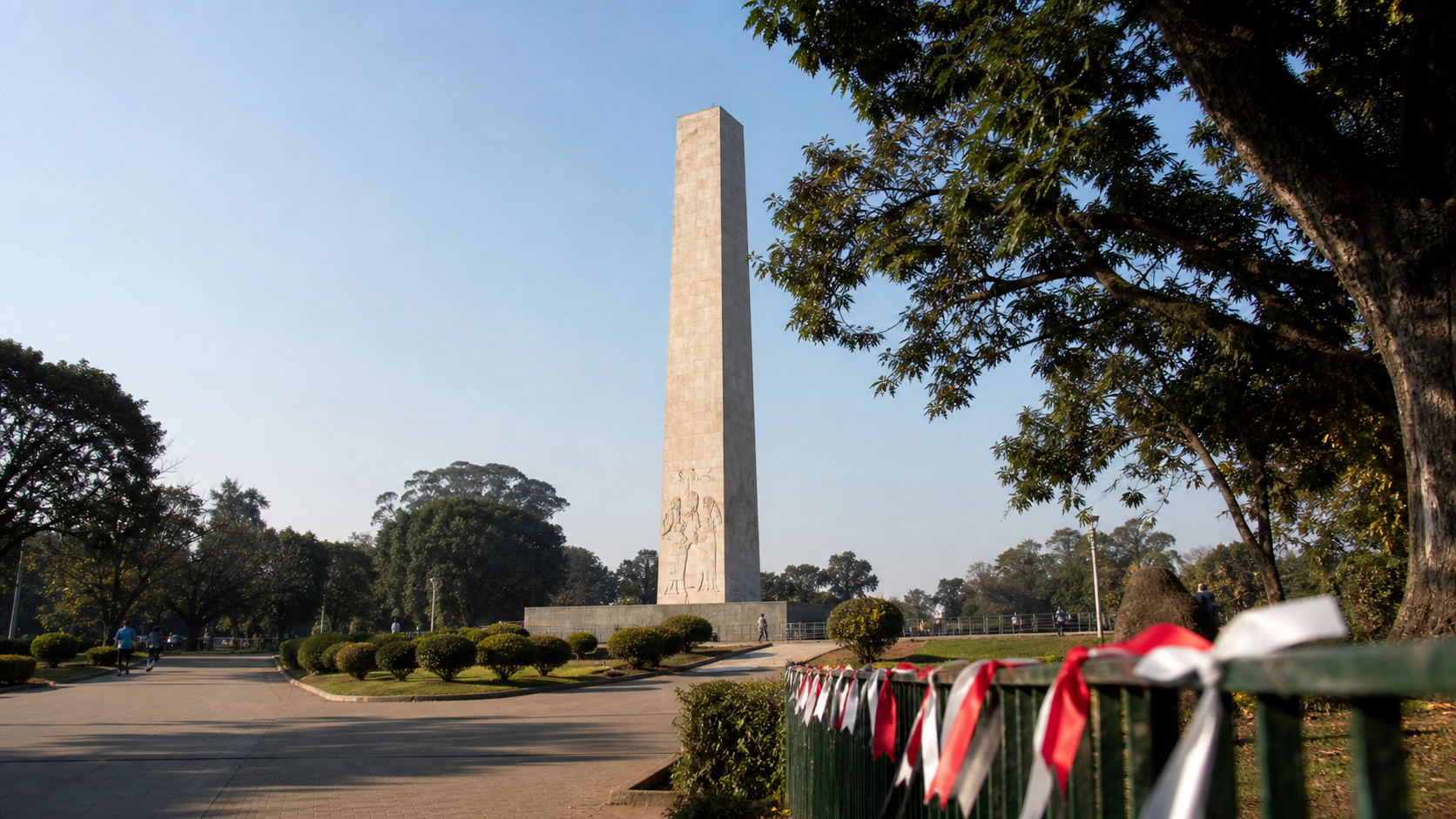Obelisco do Ibirapuera em manhã clara, com fitas nas cores de São Paulo